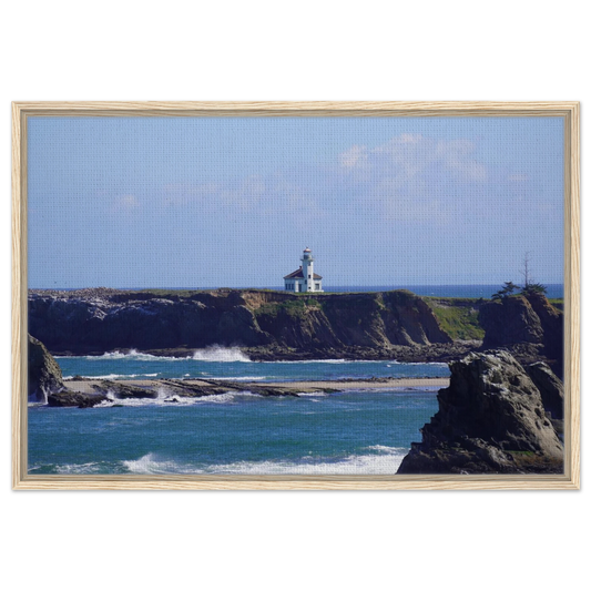 Cape Arago Lighthouse on the Oregon coast beyond rocky shoreline and blue Pacific water as canvas wall art.