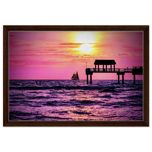 Silhouetted sailboat sailing at sunset near Clearwater Beach with vibrant pink and golden skies reflected across the Gulf waters.