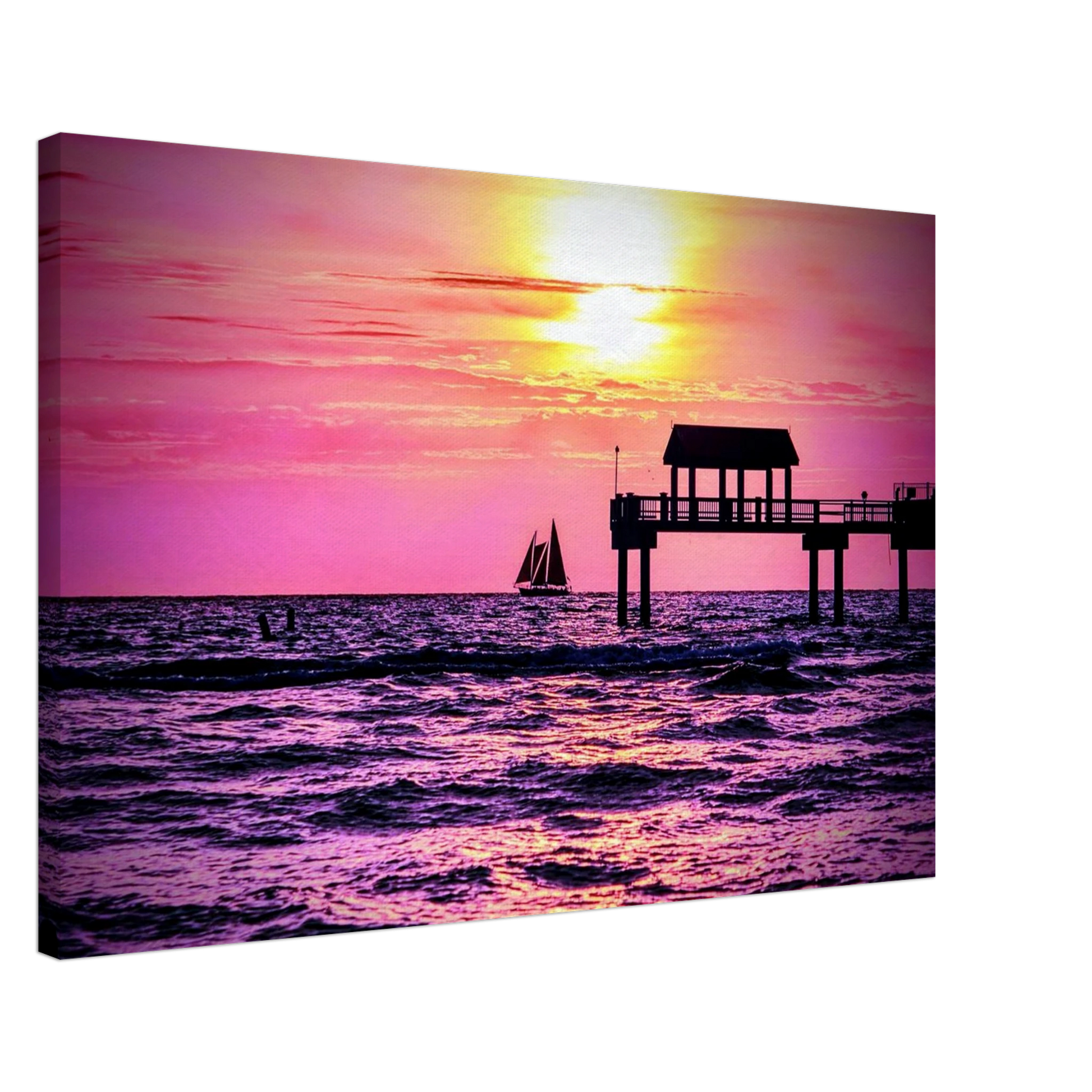 Silhouetted sailboat sailing at sunset near Clearwater Beach with vibrant pink and golden skies reflected across the Gulf waters.