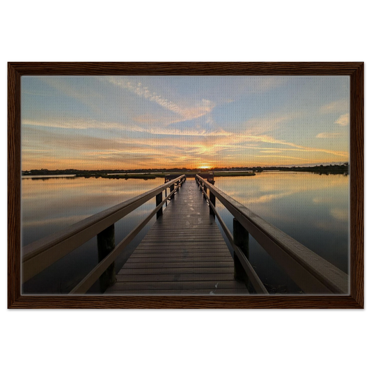 Wooden dock extending into a glowing salt water marsh at sunrise as premium coastal wall art.