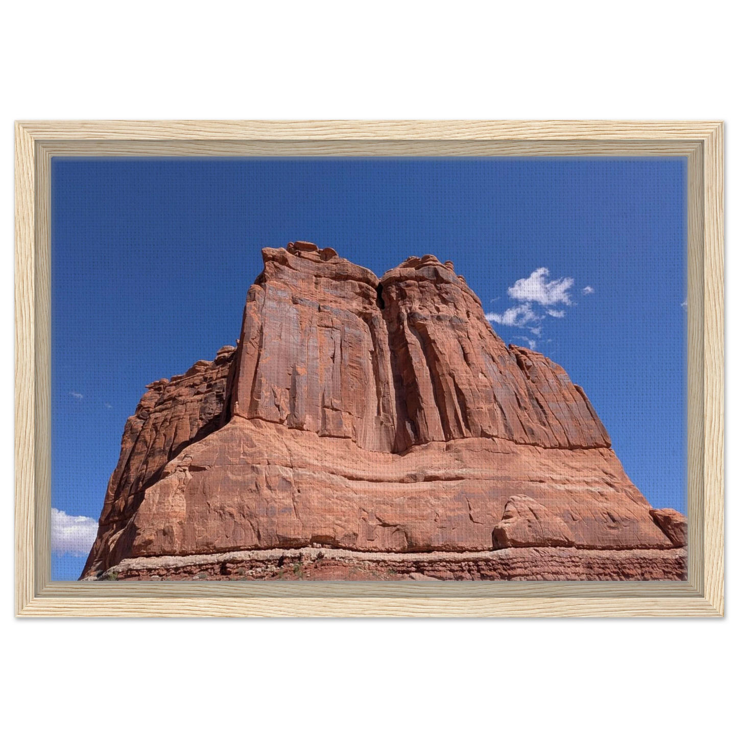 Sandstone tower in Arches National Park against blue sky as Southwest canvas wall art.